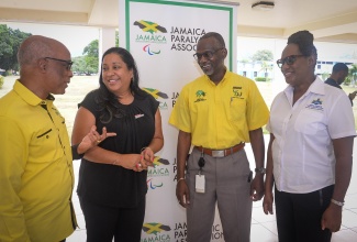 President of Jamaica Paralympic Association, Christopher Samuda, engages in discussion with (from second left) Chief Executive Officer of Digicel Foundation, Charmaine Daniels; Permanent Secretary in the Ministry of Culture, Gender, Entertainment and Sport, Denzil Thorpe; and Executive Director of the Jamaica Council for Persons with Disabilities (JCPD), Dr. Christine Hendricks, at the recent launch of Paralympic Week, held at the University of the West Indies, Mona Campus in Kingston.

