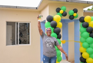New Social Housing Programme (NSHP) beneficiary, Marie Loney, proudly shows off the keys to her new three-bedroom home that was handed over to her by  Prime Minister, Dr. the Most Hon. Andrew Holness, in Maggotty Pass, St. Elizabeth, on Friday (March 14).

