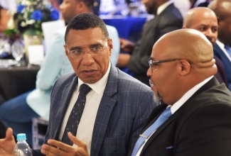 Prime Minister, Dr. the Most Hon. Andrew Holness (left), converses with President of the Manchester Chamber of Commerce, Omar Fennell,  at the Chamber’s awards banquet held at the Bloomfield Professional Centre in Mandeville on Saturday (March 29). The Prime Minister delivered the keynote address at the event, which was held under the theme: ‘Shielding Our Businesses, Recognising Excellence in 2024.’

