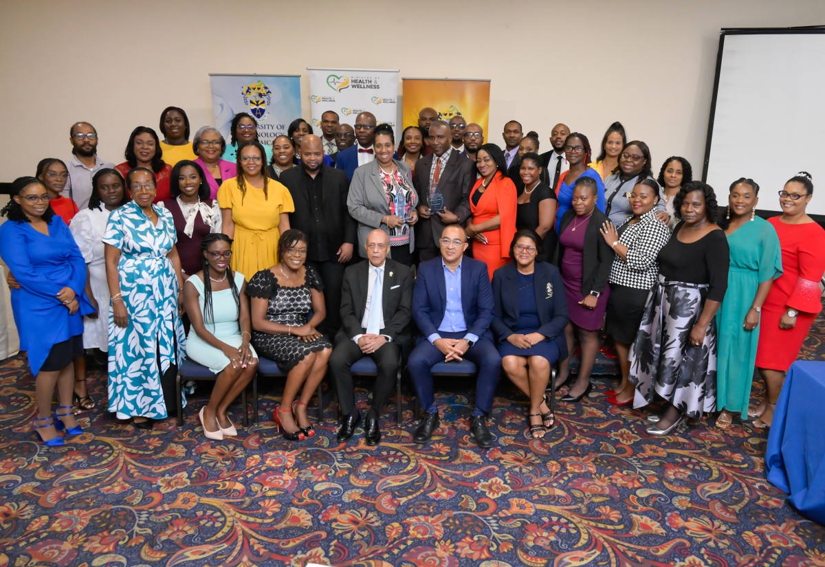 Minister of Health and Wellness, Dr. the Hon. Chistopher Tufton (seated second right), is surrounded by healthcare managers who successfully completed a leadership training programme done in collaboration with the University of Technology (UTech), at the graduation ceremony held at The Jamaica Pegasus hotel in New Kingston on Tuesday (March 11). Sharing the moment is Pro-Chancellor at UTech, Aldrick McNab (seated centre) and other staff at the University.

