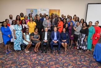Minister of Health and Wellness, Dr. the Hon. Chistopher Tufton (seated second right), is surrounded by healthcare managers who successfully completed a leadership training programme done in collaboration with the University of Technology (UTech), at the graduation ceremony held at The Jamaica Pegasus hotel in New Kingston on Tuesday (March 11). Sharing the moment is Pro-Chancellor at UTech, Aldrick McNab (seated centre) and other staff at the University.

