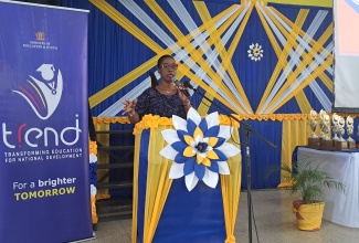 Assistant Chief Education Officer, Dr. Tamika Benjamin, who represented Minister of Education, Skills, Youth and Information, Senator Dr. the Hon. Dana Morris Dixon, delivers the keynote address during the finale of the inaugural Inter-Ministerial School Support Strategy (ISSS) Mathematics Problem-Solving Competition, held recently at Merl Grove High School in Kingston.