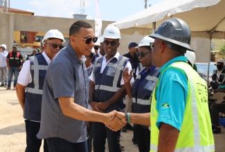 Prime Minister, Dr. the Most Hon. Andrew Holness (second left), is greeted by Pavecon Contractors Limited Managing Director, Brian Singleton, while touring the Portmore Resilience Park project site in St. Catherine on Friday (February 28). Looking on (from left) are Urban Development Corporation (UDC) Chairman, Norman Brown, Deputy General Manager, Sherlock Glenister, and Chief Architect, Maxine Fisher-Casserly. The Park’s development is being spearheaded by the UDC.