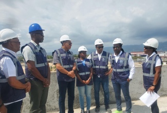 Prime Minister, Dr. the Most Hon. Andrew Holness (third left), speaks with Urban Development Corporation (UDC) Deputy General for Planning Development and Project Management, Loy Malcom (right), during a tour of the Portmore Resilience Park in St. Catherine on Friday (February 28). Looking on are (from left) UDC Chairman, Norman Brown; Member of Parliament for St. Catherine South Eastern, Robert Miller; Permanent Secretary in the Ministry of Economic Growth and Job Creation, Arlene Williams; UDC General Manager, Robert Honeyghan, and Member of Parliament for St. Catherine East Central and Minister of State in the Ministry of Foreign Affairs and Foreign Trade, Hon. Alando Terrelonge.

