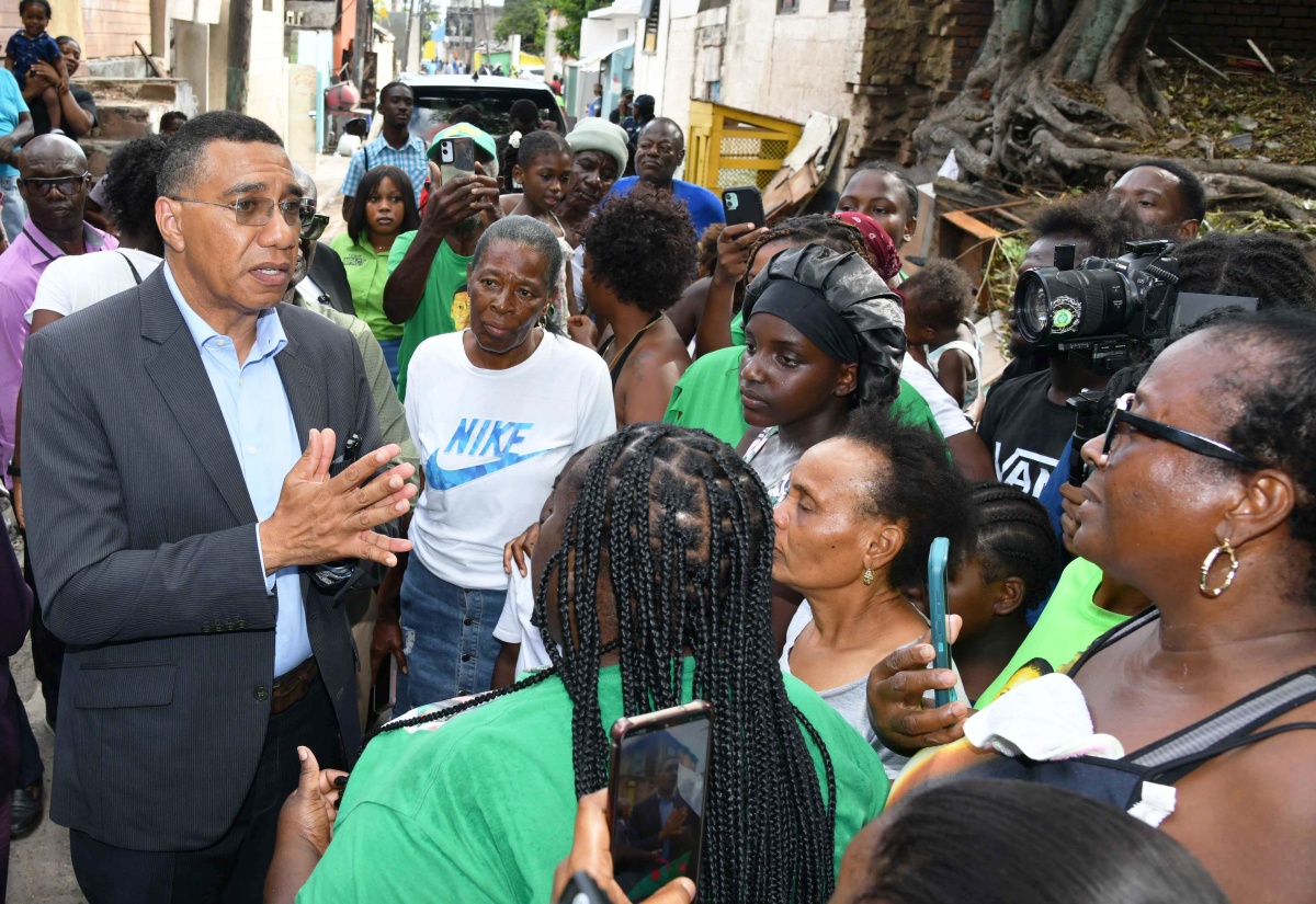 Prime Minister, Dr. the Most Hon. Andrew Holness, addresses residents of Kingston Central during Tuesday’s (March 4) tour of communities affected by a recent fire which displaced a number of householders. At right is Member of Parliament for the constituency and Minister of Local Government and Community Development, Hon. Desmond McKenzie.