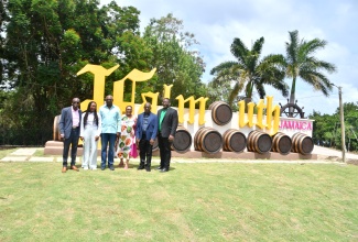 Minister of Tourism, Hon. Edmund Bartlett (third left) stands in front of the Falmouth Jam-Iconic Experience sign in Trelawny, which was unveiled on Friday ( March 28). He is joined by  (from left), Chairman of the Falmouth Destination Assurance Council, Dr. Shaun Jones; Member of Parliament for Trelawny Northern, Tova Hamilton; Member of Parliament for Trelawny Southern, Marisa Dalrymple-Philibert; Mayor of Falmouth, Councillor Collen Gager; and Executive Director of the Tourism Product Development Company (TPDCo), Wade Mars.

 