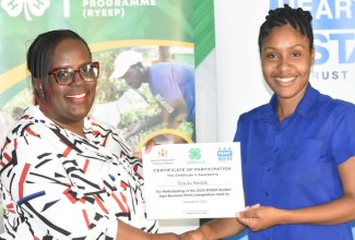 Tricia Smith (right) receives a certificate for her participation in the Rural Youth Economic Empowerment Programme (RYEEP) pitch competition from Stacey Mignott of the HEART NSTA/Trust. Mrs. Smith participated in a RYEEP training session in February.

