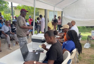 A team from the Accountant General’s Department (AGD) processes life certificates for pensioners in Westmoreland on a stop of the Mobile Life Certificate Drive.


