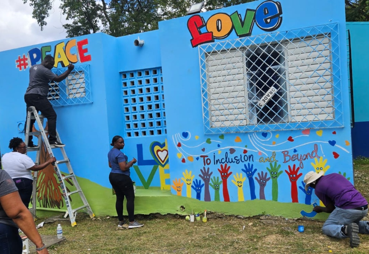 Team members from Sandals Ochi Beach Resort in St. Ann, paint a mural on the walls of the Special Education Unit at the Ocho Rios Primary school in the parish,  recently.