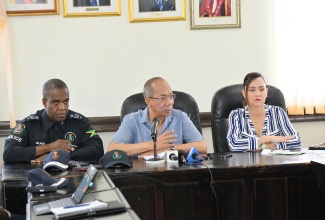 Minister of National Security, Hon. Dr. Horace Chang (centre), addresses members of the Portland business community at a recent forum held at the Portland Municipal Corporation in Port Antonio. He is flanked by Commissioner of Police, Dr. Kevin Blake (left) and Member of Parliament for Portland Eastern, Ann-Marie Vaz.