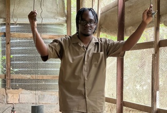 Young farmer, Cleo Jones, pauses for a picture in one of his chicken coups. The poultry and livestock farmer has over 5000 chickens, 15 pigs and 28 goats on his farm which began over two years ago after the Coronavirus (COVID-19) pandemic shuttered his party rental business.