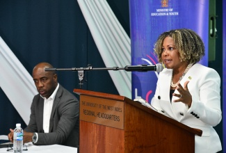 Minister of Education, Youth, Skills and Information, Senator Dr. the Hon. Dana Morris Dixon, addresses the Education Transformation Oversight Committee (ETOC) Press Conference, held at the University of the West Indies (UWI) Regional Headquarters in St. Andrew, on Friday (April 25). At left is ETOC Chairman, Dr. Adrian Stokes.

