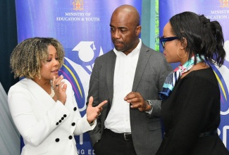 Minister of Education, Youth, Skills and Information, Senator Dr. the Hon. Dana Morris Dixon (left), is in discussion with Permanent Secretary, Dr. Kasan Troupe (right), and Chairman of the Education Transformation Oversight Committee (ETOC), Dr. Adrian Stokes, during Friday’s (April 25) ETOC Press Conference held at the University of the West Indies (UWI) Regional Headquarters in St. Andrew.