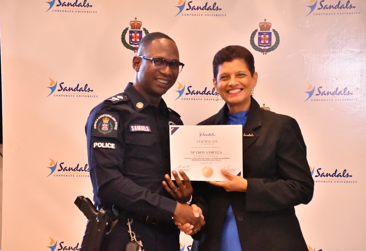 Head of the St. James Police Division, Senior Superintendent Eron Samuels (left), receives his certificate of completion from Senior Corporate Director of the Sandals Corporate University (SCU) , Dr. Luz Longsworth. Mr. Samuels was among some 210 police officers who were awarded certificates for completing SCU’s Leadership Training Initiative. Occasion was the certificate presentation ceremony for the programme, held recently at Sandals Montego Bay in St. James.

