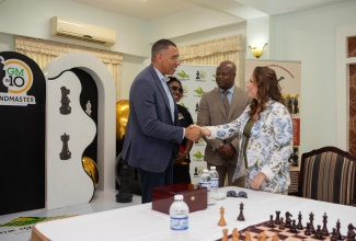 Prime Minister, Dr. the Most Hon. Andrew Holness (left), greets Hungarian Chess Grandmaster, Judit Polgár (right) during a Jamaica Chess Federation event at the Medallion Hall Hotel in Kingston on Saturday (April 19). Also sharing in the moment are Minister of Culture, Gender, Entertainment and Sport, Hon. Olivia Grange (second left) and Jamaican-American Chess Grandmaster Maurice Ashley.

