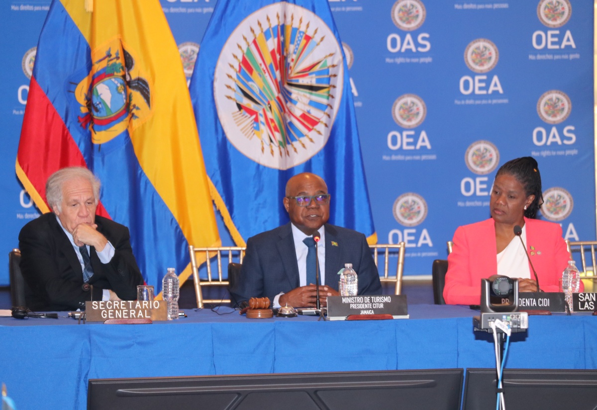 Tourism Minister and Chair of the Organization of American States (OAS) Inter-American Tourism Commission,  Hon. Edmund Bartlett (centre), addresses the opening ceremony of the 26th American Congress of Ministers and High-Level Authorities of Tourism on Thursday (April 3), at the OAS headquarters in Washington DC. He is flanked by Secretary General of the OAS, Ambassador Luis Almagro; and Chair of the Inter-American Council on Integral Development (CIDI) and Permanent Representative of St. Vincent and the Grenadines to the OAS, Ambassador Lou-Anne Gilchrist. This year’s Congress is exploring how cultural heritage, community-based initiatives, and inclusive tourism can drive sustainable economic development and environmental stewardship across the region.