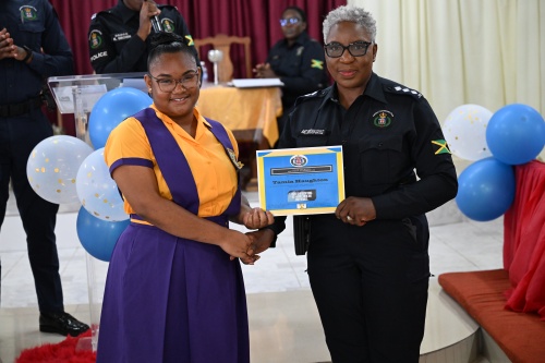 Grade 10 student at the Hopewell High School, Tamia Haughton (left), accepts a certificate from Deputy Superintendent in charge of Operation/Technical Officer, Angela McIntosh Gayle, during the ‘I Have Triumph’ Award Ceremony held at the Christian Fellowship Church in Lucea, Hanover, on Saturday (March 29).