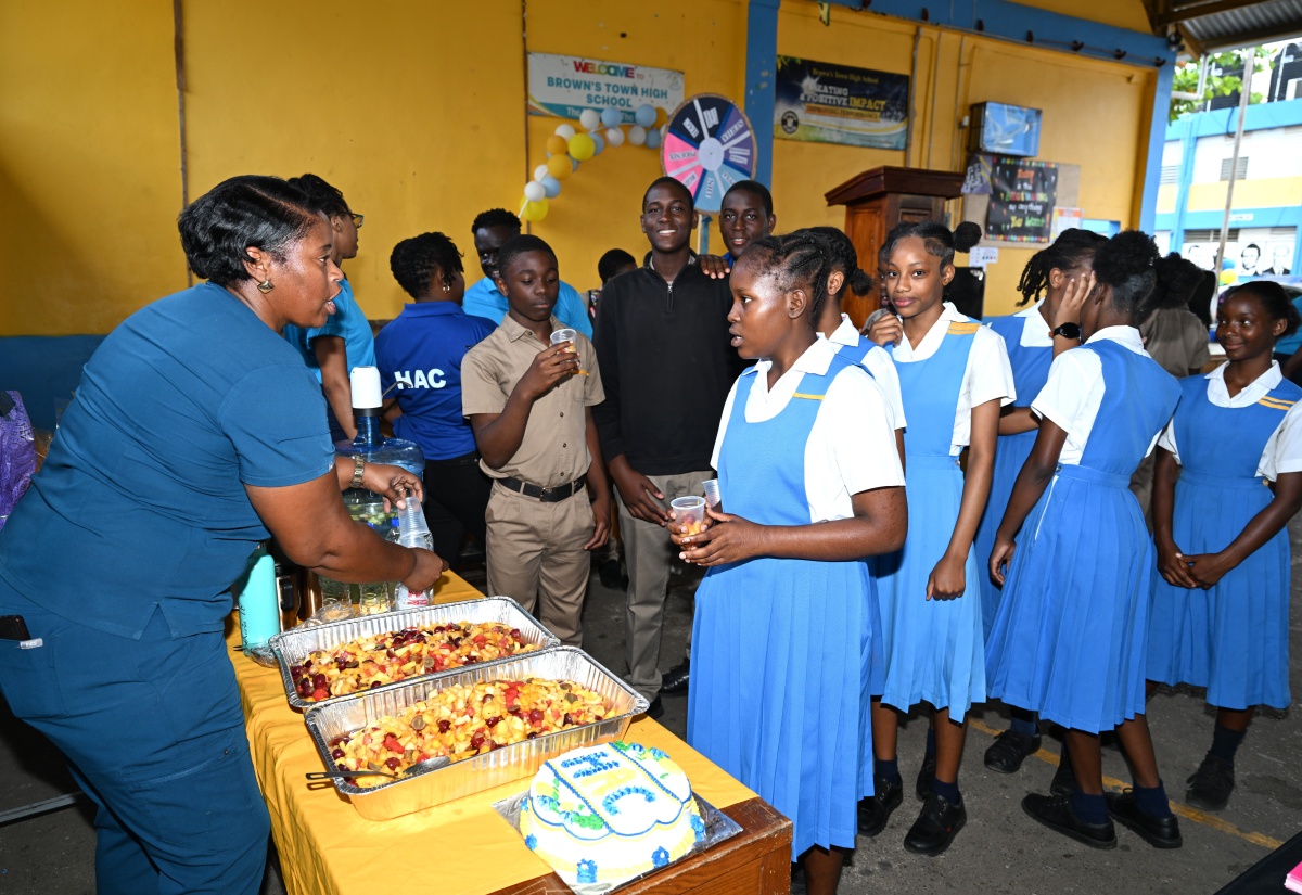 School Nurse, Fredrica Frazer-Stewart, serving fruit salad to students of Brown’s Town High School in St. Ann, during the institution’s major health fair, held on Tuesday, April 8.

