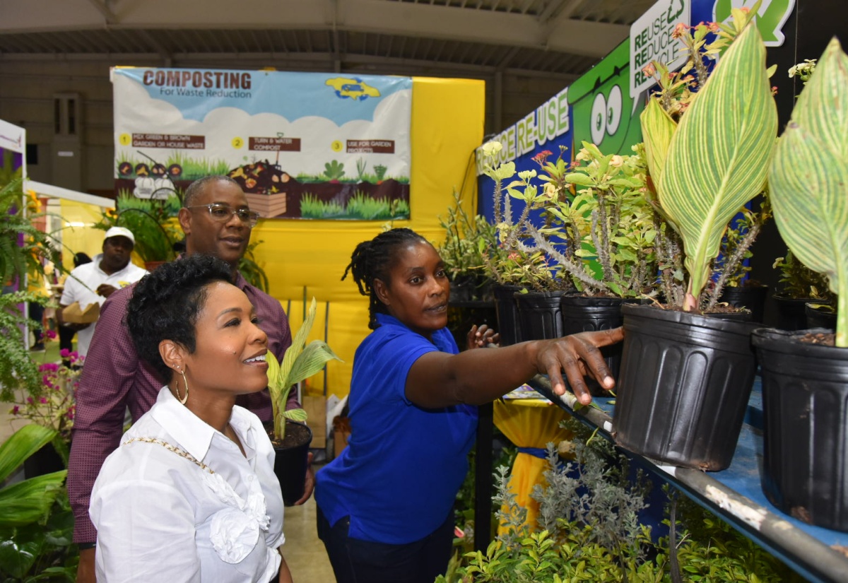Head of Marketing, Scotia Bank Jamaica, Tonya Russell (left) and Senior Vice President, Commercial Banking, Scotia Centre, Morris Nelson (centre), are shown potted plants by a representative from the National Solid Waste Management Authority (NSWMA), Claudia Nelson, during a tour of the Authority's exhibition booth at EXPO Jamaica 2025, at the National Indoor Sports Centre in Kingston on April 4.

