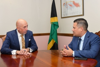 Minister without Portfolio in the Ministry of Economic Growth and Job Creation, Hon. Matthew Samuda (right), converses with the Ambassador of Spain to Jamaica, His Excellency José María Fernández López de Turiso (left) during a courtesy call at the Ministry’s New Kingston office on Tuesday (April 29).