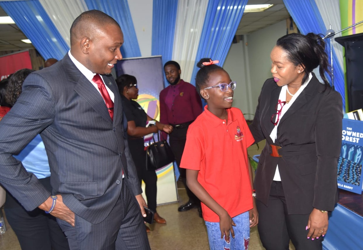 Permanent Secretary in the Ministry of Education, Skills, Youth and Information, Dr. Kasan Troupe (centre), and Director General of the Jamaica Library Service (JLS), Maureen Thompson, converse with JLA Board Chairman, Paul Lalor, during the 2025 National Reading Competition’s media launch at the Kingston and St. Andrew Parish Library on April 15.