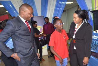 Permanent Secretary in the Ministry of Education, Skills, Youth and Information, Dr. Kasan Troupe (centre), and Director General of the Jamaica Library Service (JLS), Maureen Thompson, converse with JLA Board Chairman, Paul Lalor, during the 2025 National Reading Competition’s media launch at the Kingston and St. Andrew Parish Library on April 15.