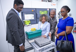 Minister of Education, Skills, Youth and Information, Senator Dr. the Hon. Dana Morris Dixon (third right), looks at the features of the metal 3D printer in the Industrial and Mechanical Engineering Laboratory at the University of Technology (UTech), during a tour of the campus in Papine, St. Andrew, on Tuesday (April 15). Others (from left) are Director of the department, Hugh Cargill; President of the University, Dr. Kevin Brown; and Assistant Chief Education Officer at the Ministry, Dr. Tamika Benjamin.