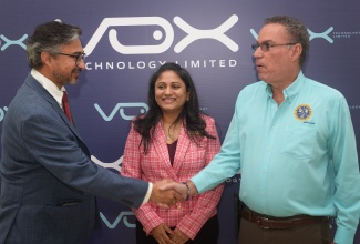 Minister of Science, Energy, Telecommunications and Transport, Hon. Daryl Vaz (right), greets High Commissioner of India to Jamaica, His Excellency Shri Mayank Joshi (left,) at the launch of Vox Technology Limited at the Jamaica Pegasus Hotel in New Kingston on Friday (April 25). Sharing in the moment is Chief Executive Officer (CEO) of Vox Technology, Ranjita Sanumpudi.