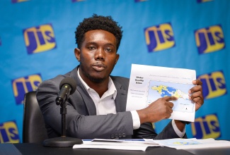 Environmental Officer at the Water Resources Authority (WRA), Orlando Thomas, points to a water quality atlas, while addressing a recent Jamaica Information Service (JIS) Think Tank.