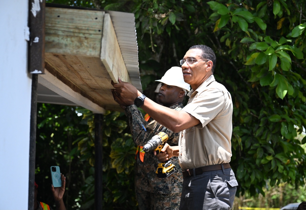 Prime Minister, Dr. the Most Hon. Andrew Holness, assists with construction activities on the caretaker's cottage at the Mason River Environmental and Research Park in Clarendon during today's (May 23) Labour Day activities. Labour Day 2025 is being celebrated under the theme 'Protect the Environment: Our Land, Our Duty, Our Future'. The slogan is 'Jamaica Nice, Protect Wi Paradise'.