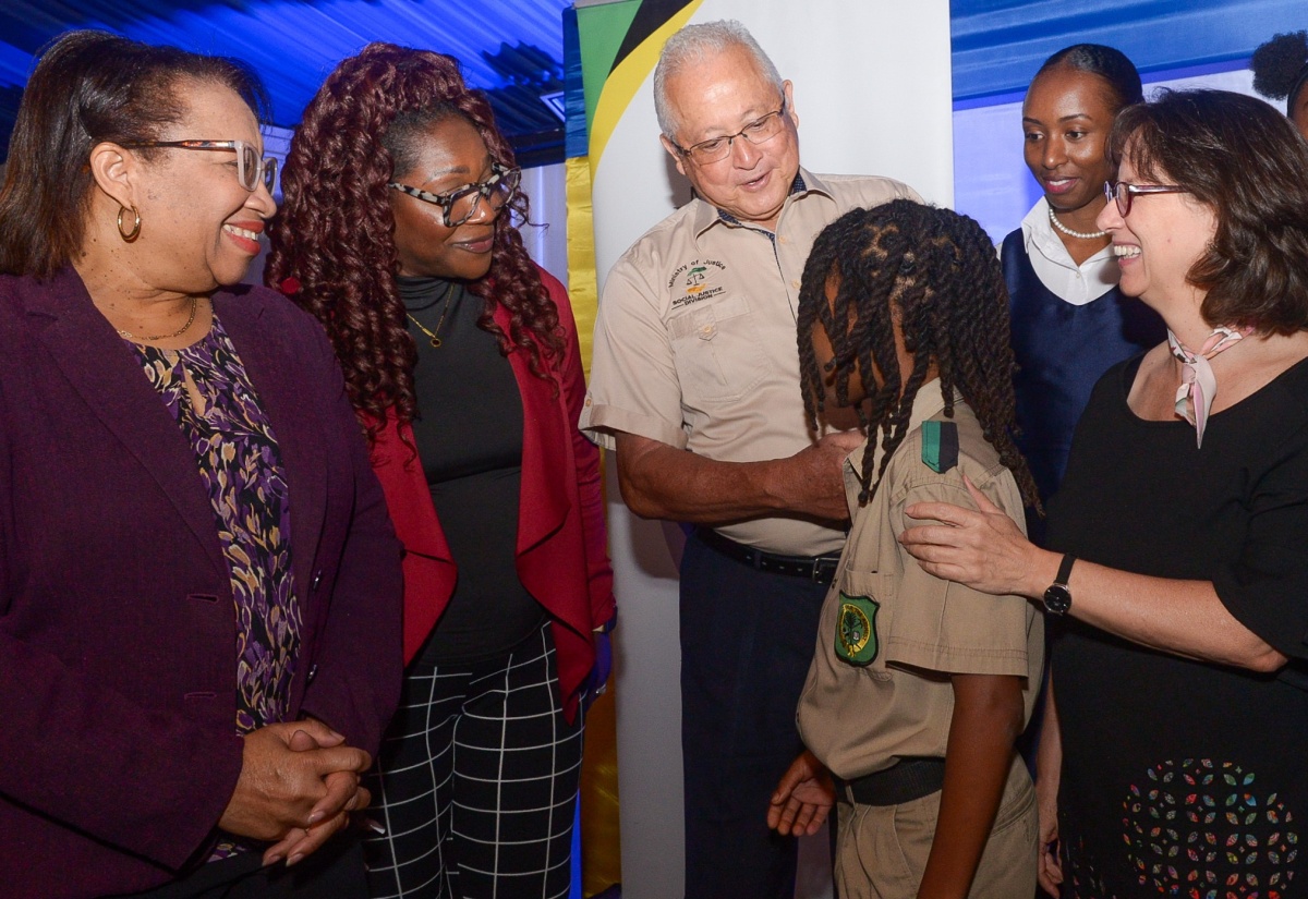 Justice Minister, Hon. Delroy Chuck (third left), interacts with Calabar High School student André Barton (third right) during the Ministry’s Child Diversion Forum at the Terra Nova All-Suite Hotel in St. Andrew on May 2. Sharing the moment (from left) are Permanent Secretary in the Ministry, Grace Ann Stewart McFarlane; Senior Director, National Council on Drug Abuse (NCDA), Denise Bingham; Director of the Child Diversion Branch (CDB) in the Justice Ministry’s Social Justice Division, Venisa Clarke, and Representative for the United Nations Children’s Fund (UNICEF) Jamaica Representative, Olga Isaza.