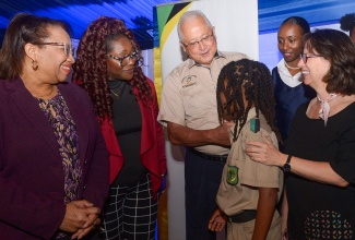 Justice Minister, Hon. Delroy Chuck (third left), interacts with Calabar High School student André Barton (third right) during the Ministry’s Child Diversion Forum at the Terra Nova All-Suite Hotel in St. Andrew on May 2. Sharing the moment (from left) are Permanent Secretary in the Ministry, Grace Ann Stewart McFarlane; Senior Director, National Council on Drug Abuse (NCDA), Denise Bingham; Director of the Child Diversion Branch (CDB) in the Justice Ministry’s Social Justice Division, Venisa Clarke, and Representative for the United Nations Children’s Fund (UNICEF) Jamaica Representative, Olga Isaza.