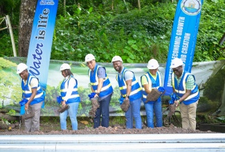 Prime Minister, Dr. the Most Hon. Andrew Holness (third left) breaks ground for the Castleton Pipeline Project, in St. Mary on Friday (May 16). Also participating are (from left) Regional Manager for National Water Commission North East, Richard Williams; Permanent Secretary in the Ministry of Economic Growth and Job Creation, Arlene Williams; Acting Vice President of Operations at the NWC, Herman Fagan; State Minister in the Ministry of Labour and Social Security and Member of Parliament for St. Mary South Eastern, Dr. the Hon. Norman Dunn and Councillor for the Castleton Division, Lenford Danvers. The groundbreaking ceremony was held at the Castleton Botanical Gardens in St. Mary.