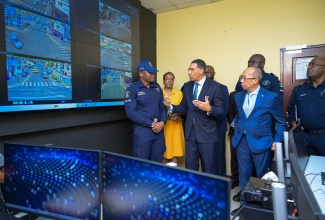 Prime Minister, Dr. the Most Hon. Andrew Holness (second left), is in discussion with Corporal Alex Pearce (left) during a tour of the control centre for the Olympic Way JamaicaEye Monitoring Centre located at the Olympic Gardens Police Station in West Central St. Andrew, during the official launch on May 6. They are joined by Deputy Prime Minister and Minister of National Security, Hon. Dr. Horace Chang; Permanent Secretary in the Ministry, Ambassador Alison Stone Roofe (second left) and other representatives from the Jamaica Constabulary Force (JCF) and the Ministry.

