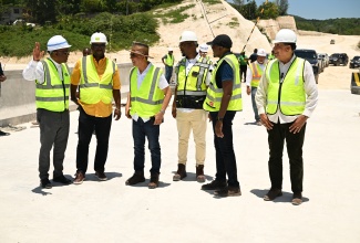 Deputy Prime Minister and Minister of National Security, Hon. Dr. Horace Chang (third from left), listens to a point from Government Senator, Charles Sinclair (right) during a tour of sections of the Montego Bay Perimeter Road Project in St. James on Thursday, May 8. Sharing in the conversation (l-r) are Deputy Speaker of the House of Representatives, Heroy Clarke; Managing Director of the National Road Operating and Constructing Company (NROCC), Stephen Edwards; Minister without Portfolio in the Ministry of Economic Growth and Job Creation, Hon. Robert Morgan; and Minister of State in the Office of the Prime Minister (West), Homer Davis.