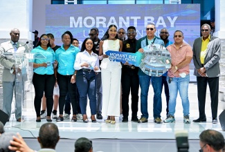 Prime Minister, Dr. the Most Hon. Andrew Holness (fourth right), pauses for a photo opportunity with St. Thomas-based business owners, who are among the first clients who will occupy spaces at the Morant Bay Urban Centre. Event was the ribbon-cutting ceremony to mark the completion of the project on May 15.