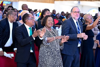 Minister of Culture, Gender, Entertainment and Sport, Hon. Olivia Grange (second left), joined by (from left) State Minister in the Ministry of Labour and Social Security, Dr. the Hon. Norman Dunn; Leader of the Opposition, Mark Golding; and Minister of Finance and the Public Service, Hon. Fayval Williams, participate in praise and worship during Sunday’s (May 18) National Workers' Week and Labour Day Thanksgiving Church Service held at the Portmore Holiness Christian Church in St. Catherine.