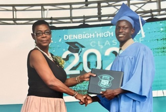 Dave Flowers receives his high-school diploma during his fifth-form graduation ceremony in 2022 from Denbigh High School in Clarendon. He is among thousands of beneficiaries of the NCB Foundation’s CSEC/CAPE National Bursary Programme.

