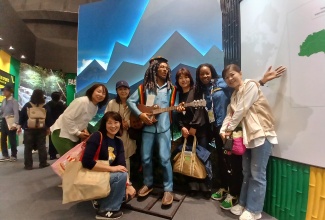 Commissioner General of Section, Jamaica Pavilion, Maureen Smith (second right), and visitors to the Jamaica Pavilion at Expo 2025 Osaka, Kansai, Japan, pose for a picture with the Bob Marley statue.