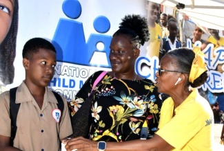 Chairperson Emerita of the National Child Month Committee, Dr. Pauline Mullings (right), engages in conversation with student Royheem Reid (left), parent Ruth Doniel (center), and St. Joseph’s Infant School student, De’Andra Hall. They were at a National Children’s Day event held at the St. William Grant Park in Downtown, Kingston on Friday (May 16).