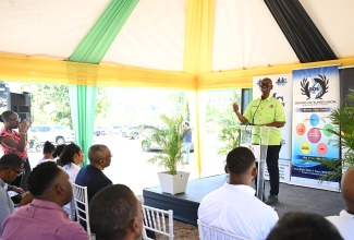 Minister of Local Government and Community Development, Hon. Desmond McKenzie, delivers remarks during the official opening of a new kitchen facility at the St. James Infirmary on May 2.


