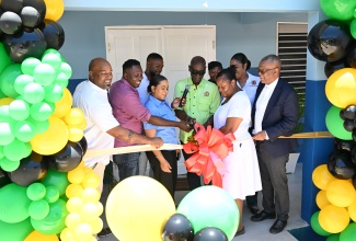 Minister of Local Government and Community Development, Hon. Desmond McKenzie (centre), leads the ribbon-cutting exercise marking the official opening of the St. James Infirmary’s new $23 million kitchen on Friday (May 2). He is joined by (from left): Deputy Mayor of Montego Bay, Councillor Dwight Crawford; Councillor for the Montego Bay West Division, Damion Brown; Montego Bay Mayor, Councillor Richard Vernon; Secretary of the Board of Supervision, Treka Lewis; Minister of the Springfield Wesleyan Holiness Church, Sandra Mills; Matron at the Infirmary, Jacqueline Wilson; Chief Executive Officer, St. James Municipal Corporation, Naudia Crosskill; and Government Senator, Charles Sinclair.