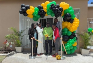 Minister of Local Government and Community Development, Hon. Desmond McKenzie (third left), cuts the ribbon for the official opening of the new $16-million Matron’s Quarters at the Hanover Infirmary, on May 1. Sharing the moment (From left) are Member of Parliament for Hanover Western, Tamika Davis; Deputy Mayor of Lucea, Andria Dehaney-Grant; Matron Kayon Dyer; and Chief Executive Officer (CEO) of the Hanover Infirmary, David Gardener.

