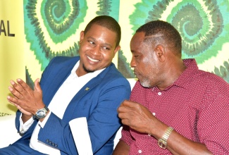 Minister of Agriculture, Fisheries and Mining, Hon. Floyd Green (left), converses with Jamaica Agricultural Society (JAS) President, Owen Dobson, during Tuesday’s (April 29) ‘Thank A Farmer’ Wellness Fair at Hope Gardens in St. Andrew. 

