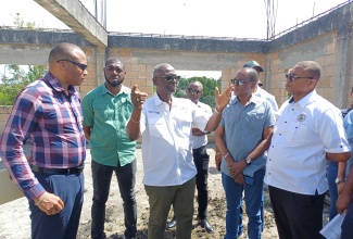 Minister of Local Government and Community Development, Hon. Desmond McKenzie (centre), makes a point during a tour of the Spalding Market in Clarendon on Wednesday (May 14). Listening (from left) are Chief Executive Officer of the Clarendon Municipal Corporation, Rohan Blake; former Senator Warren Newby; Mayor of Clarendon, Joel Williams; and Councillor for the Ritchies Division, Trevor Gordon.