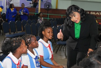 Chief Executive Officer of the Child Protection and Family Services Agency (CPFSA), Laurette Adams-Thomas, engages with (from left) Toni-Ann Skervin, Zendaya Nosworthy and Azaria Watkins from the Naggo Head Primary School in Portmore, St. Catherine.  Occasion was the National Day of Prayer for the nation’s children, organised by the National Child Month Committee (NCMC) as part of Child Month activities.  The event was held at the Celebration Church in Portmore on May 28.

