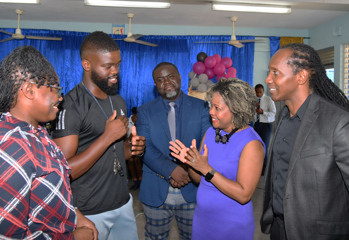 Minister of Education, Skills, Youth and Information, Senator Dr. the Hon. Dana Morris Dixon (second right), converses with Head of Department for Physical Education and Sport at Cedar Grove Academy in Portmore, St. Catherine, Kennoy Douglas (second left), during a visit to the school on May 8. Listening (from left) are Head of the Department for Human Ecology, Tameika Edman-Johnson; Acting Principal, Howard Brown, and Minister of State in the Ministry of Foreign Affairs and Foreign Trade, and Member of Parliament for St. Catherine East Central, Alando Terrelonge. Senator Morris Dixon’s visit was part of a tour of schools in the Ministry’s Region Six that also included Gregory Park Primary, Naggo Head Infant, and Naggo Head Primary.

