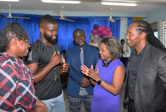 Minister of Education, Skills, Youth and Information, Senator Dr. the Hon. Dana Morris Dixon (second right), converses with Head of Department for Physical Education and Sport at Cedar Grove Academy in Portmore, St. Catherine, Kennoy Douglas (second left), during a visit to the school on May 8. Listening (from left) are Head of the Department for Human Ecology, Tameika Edman-Johnson; Acting Principal, Howard Brown, and Minister of State in the Ministry of Foreign Affairs and Foreign Trade, and Member of Parliament for St. Catherine East Central, Alando Terrelonge. Senator Morris Dixon’s visit was part of a tour of schools in the Ministry’s Region Six that also included Gregory Park Primary, Naggo Head Infant, and Naggo Head Primary.

