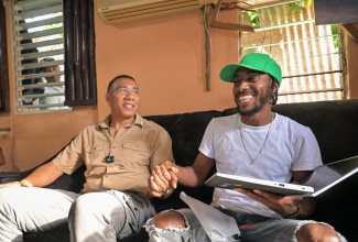 Prime Minister, Dr. the Most Hon. Andrew Holness (left), receives thanks from music producer, Junior McGregor, for gifting him a laptop. The presentation took place during Dr. Holness’ Labour Day (May 23) visit to Mr. McGregor’s recording studio on Lime Tree Lane in his St. Andrew West Central constituency.

