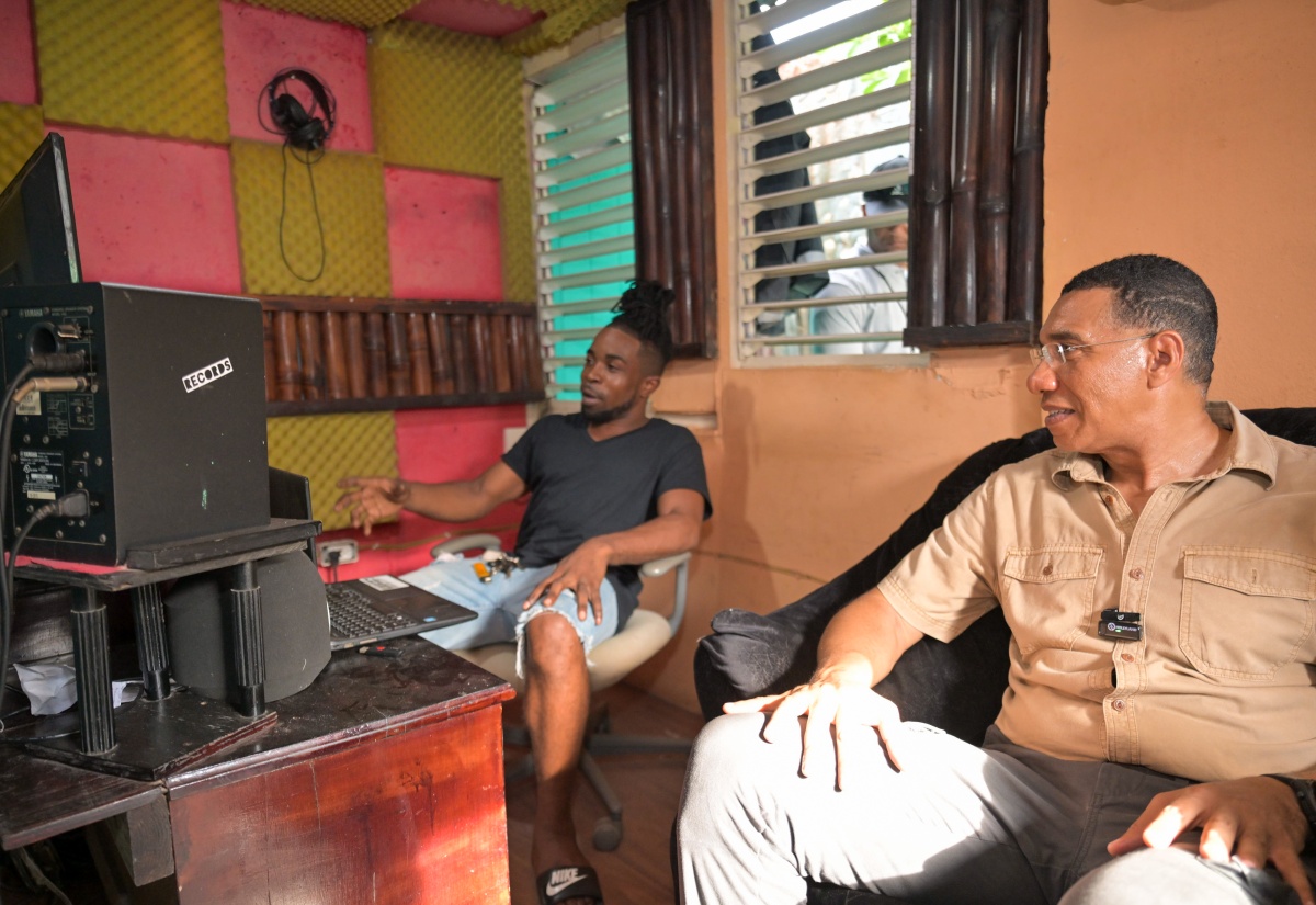 Prime Minister Holness Gifts Laptop to Emerging Music Producer